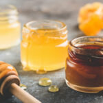 Selection of honey in small honey jars. Closeup view, toned image