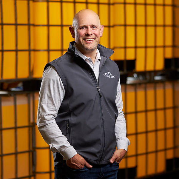 Alan Turanski in front of honey totes